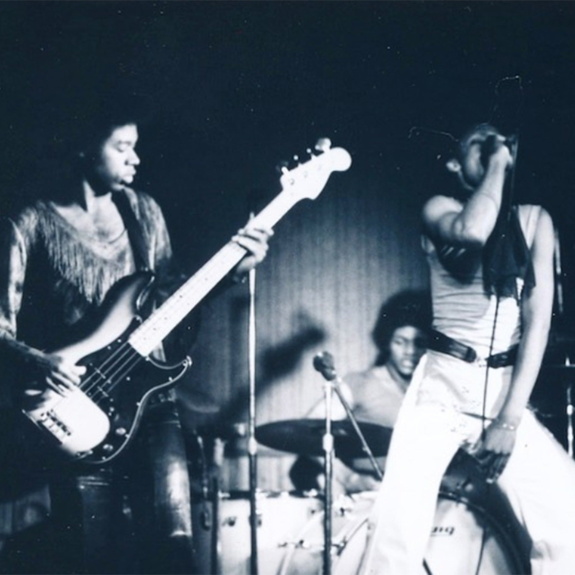 Black and white photo of a band performing on stage
